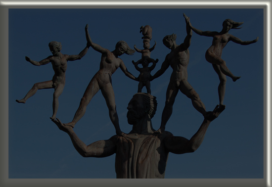 statue of large bronze man juggling 6 people